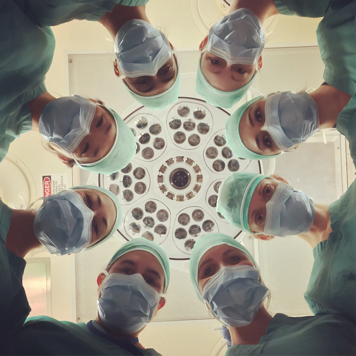 Surgical team looking down at the operating table